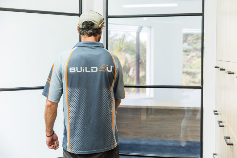 Builder with Build4U logo on his shirt working with a renovation
